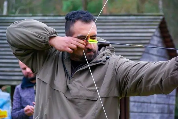 Bogen wird gespannt, Pfeil zielt auf ein Ziel