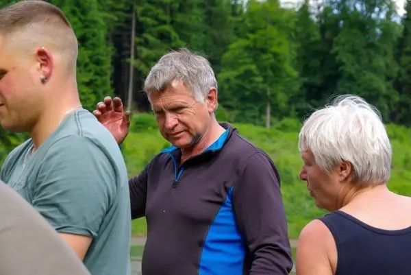 Person spricht mit anderen Personen im Freien
