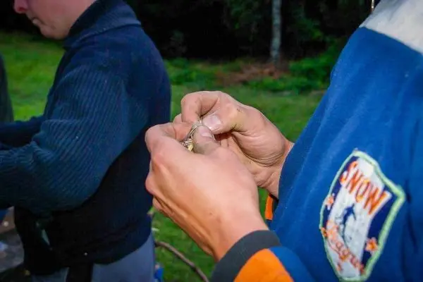 Hände binden eine Schnur zu einer Schlaufe für eine Konstruktion