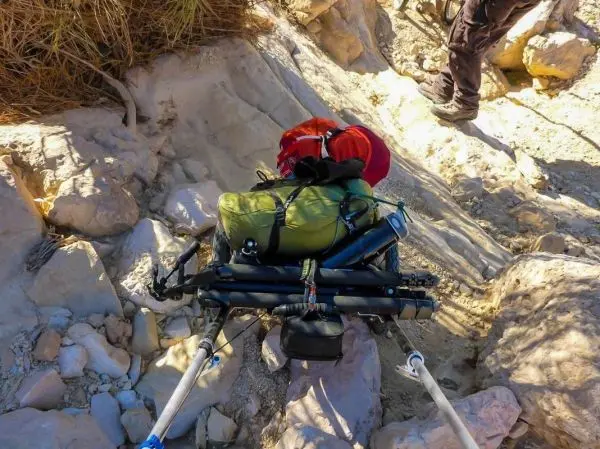 Rucksack auf einem Schlitten über felsigem Untergrund gezogen