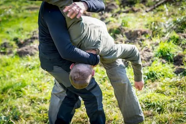 Kampfsituation mit zwei Personen, eine Person hält die andere im Griff