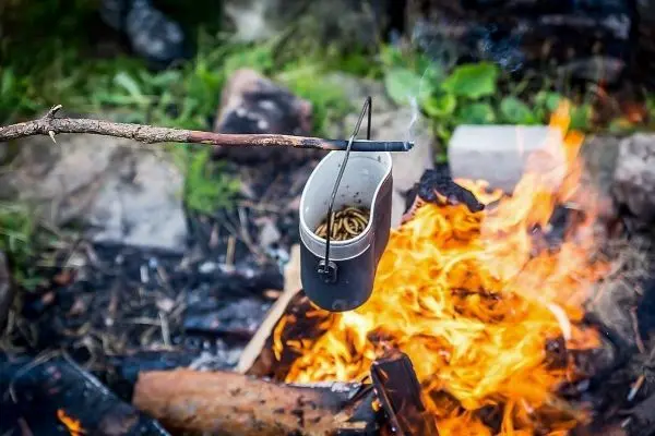 Kessel hängt über dem Feuer und erhitzt den Inhalt