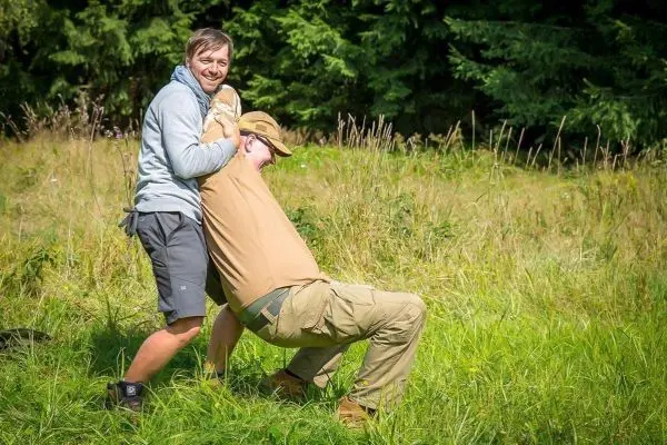 Zwei Personen üben eine Technik zur Unterstützung in einer Wiese aus