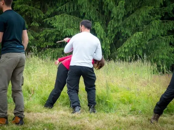 Person führt eine Übung mit einem anderen Teilnehmer durch