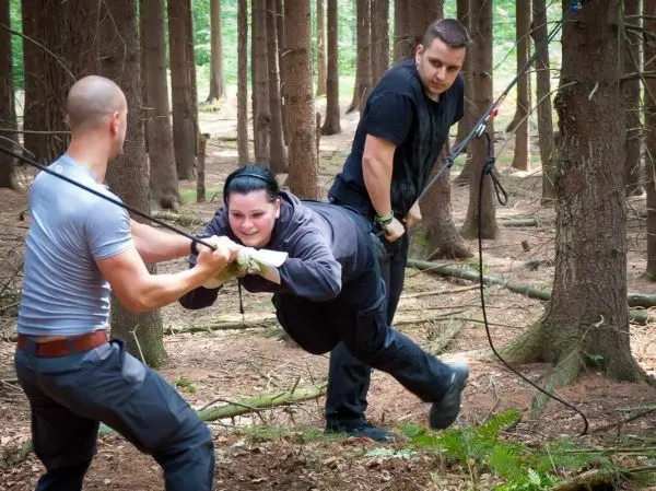 Selbstgebaute Seilquerung wird von zwei Personen unterstützt, während eine dritte Person überquert