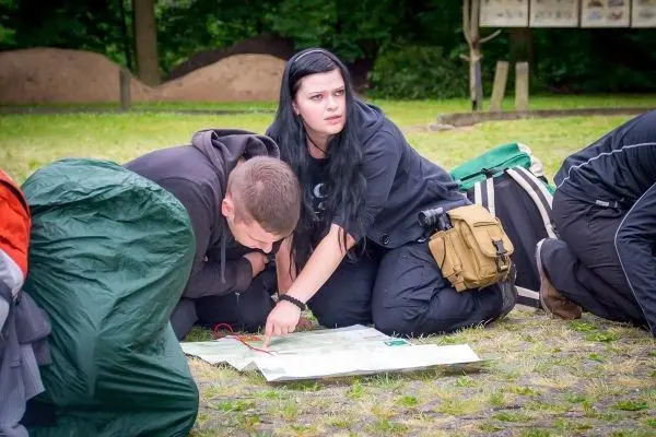Zwei Personen knien auf dem Boden und studieren eine Karte