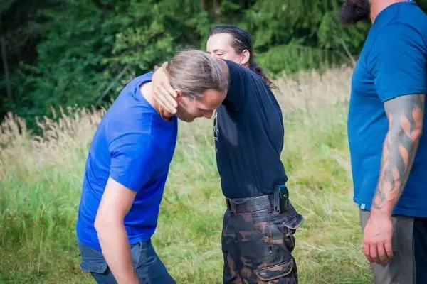 Zwei Personen üben eine Technik zur Kontrolle des Gegners im Freien