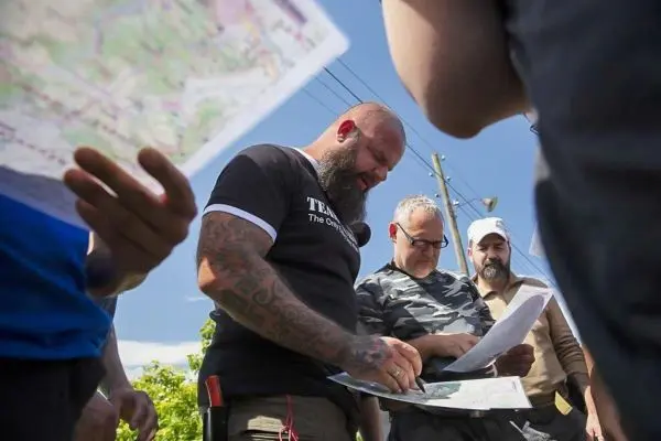 Mehrere Personen betrachten Karten und diskutieren über die Route