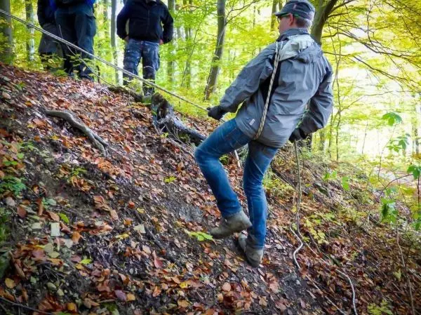Person seilt an einem Seil einen Hang hinunter beim Überlebenstraining