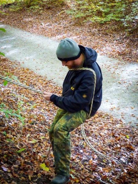 Seil wird für eine Abseiltechnik in einem Waldgebiet gesichert