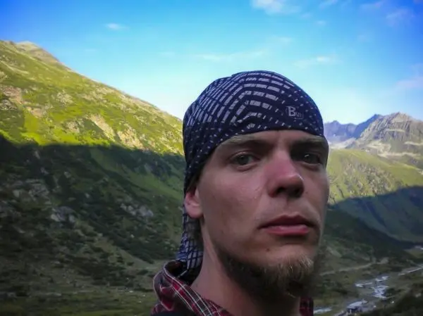 Person mit kopftuch vor einer berglandschaft