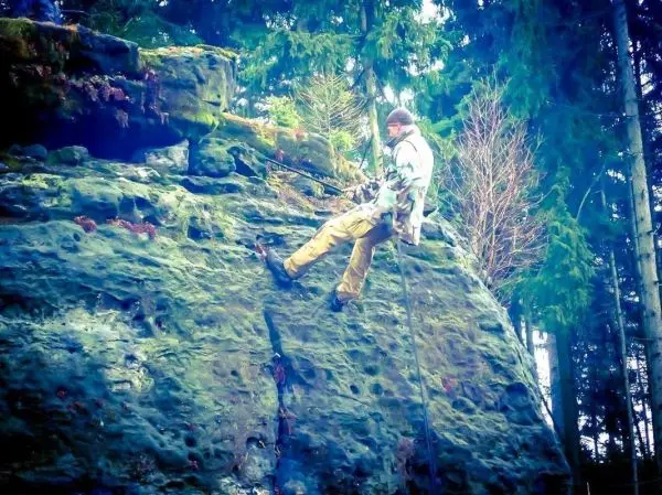 Abseilen an einer Felswand mit Seil und Kletterausrüstung