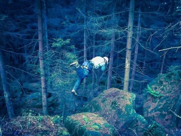 Seilquerung zwischen Bäumen mit Sicherheitsausrüstung und Karabiner