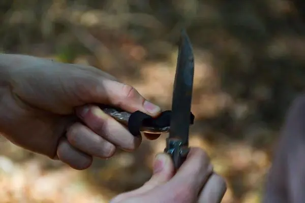 Messer wird mit einer Hand gehalten und mit der anderen Hand geschärft