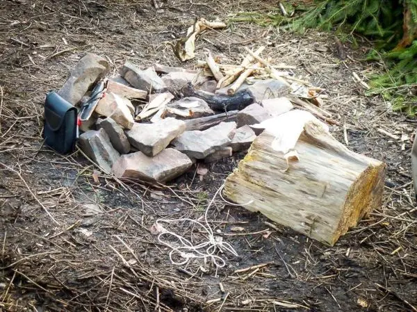 Steine und Holzstücke um ein Feuerlager angeordnet