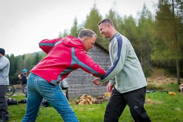 Zwei Personen führen eine Übung zur Selbstverteidigung durch