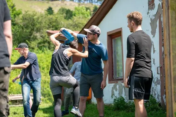 Person übt Selbstverteidigungstechniken mit Wasserflasche gegen Angreifer